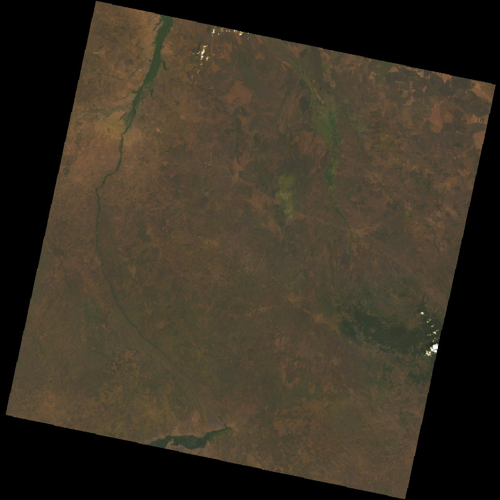 Landsat 9 satellite image of the Imatong Mountains, 5 February 2025 — over eleven years into the South Sudanese civil war. Dry-season palette: tan and brown landscape across the lowlands, dark forested block of the Imatong massif in the upper right, river courses traced in green. Acquired with virtually no cloud cover.